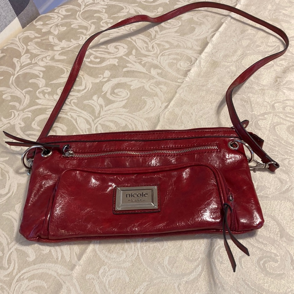 Nicole Miller red leather cross body bag.  Very good condition.